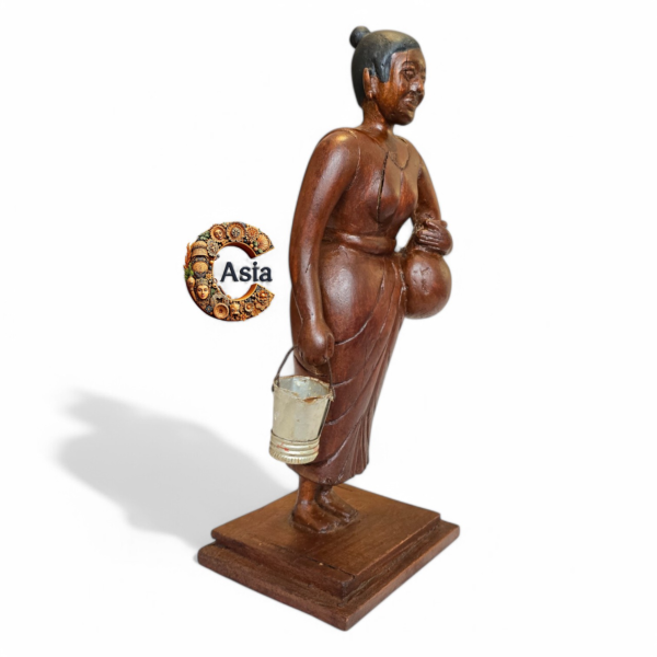Side view of vintage wooden village woman figurine holding a bucket – handcrafted solid wood statue