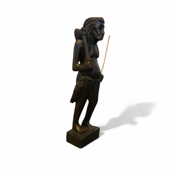 Side view of handcrafted wooden statue of tribal hunter with axe and pouch – Crafts Asia