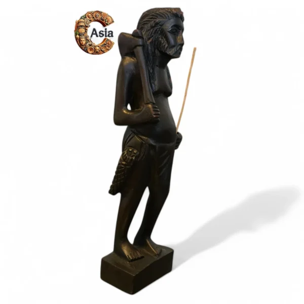 Side view of handcrafted wooden statue of tribal hunter with axe and pouch – Crafts Asia
